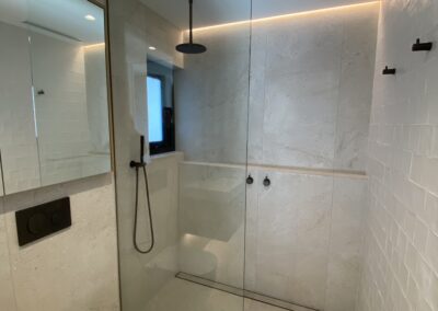 custom glass shower frame with stainless steel finishes | contemporary stainless solutions