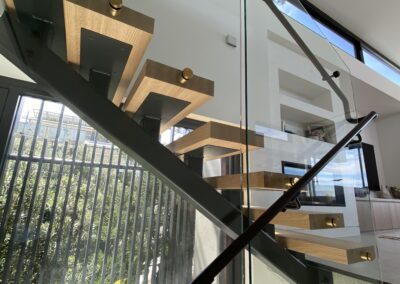 Glass staircase balustrades and stainless steel handrails | Matte black powder coated | residential property