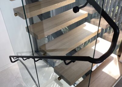 Custom, modern stainless steel powder coated matte black handrails for staircase with glass balustrades