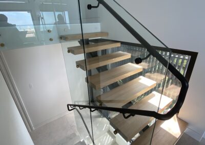 tall glass walls for internal two-tier staircase | stainless steel finishes and handrails | Contemporary Stainless Solutions