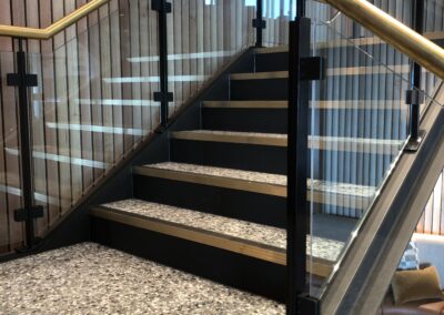 Glass balustrades with brass handrails | Glencore Newcastle